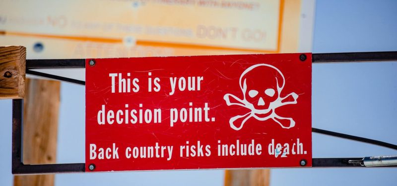 Red and white sign displayed at Snowmass, near Aspen, Colorado, warning of potentailly deadly concequences of going further.